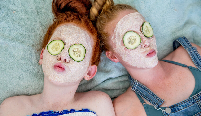 two girls with facial masks on